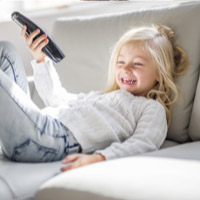 Little girl with remote lounging