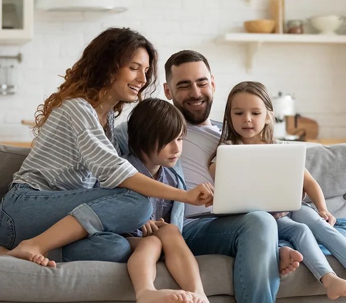 Family on couch using their devices