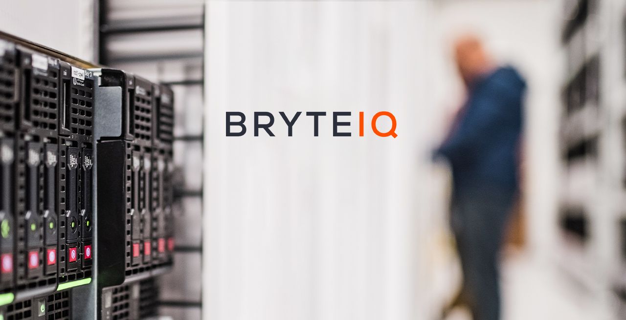 Data center with worker blurred in the background, with Bryte IQ logo